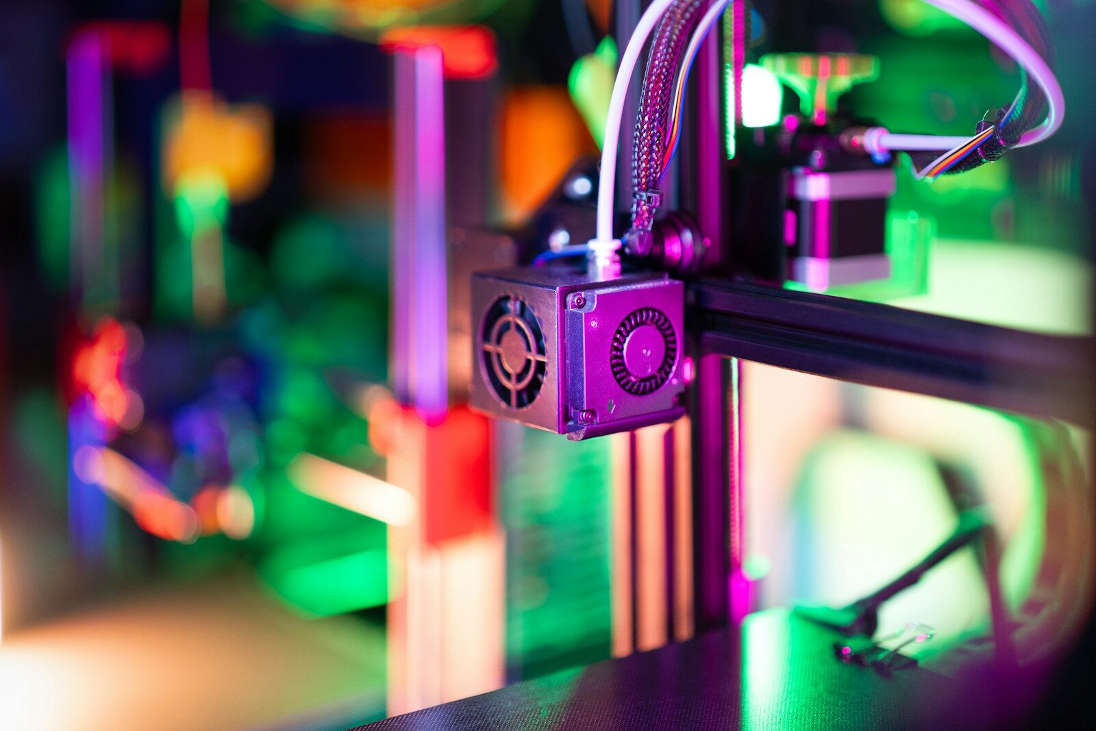 A close up of a 3D printer with a blurry background